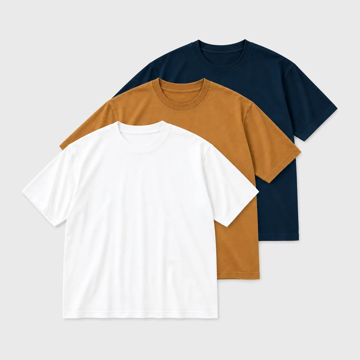 White, camel and navy oversized t-shirts layered together