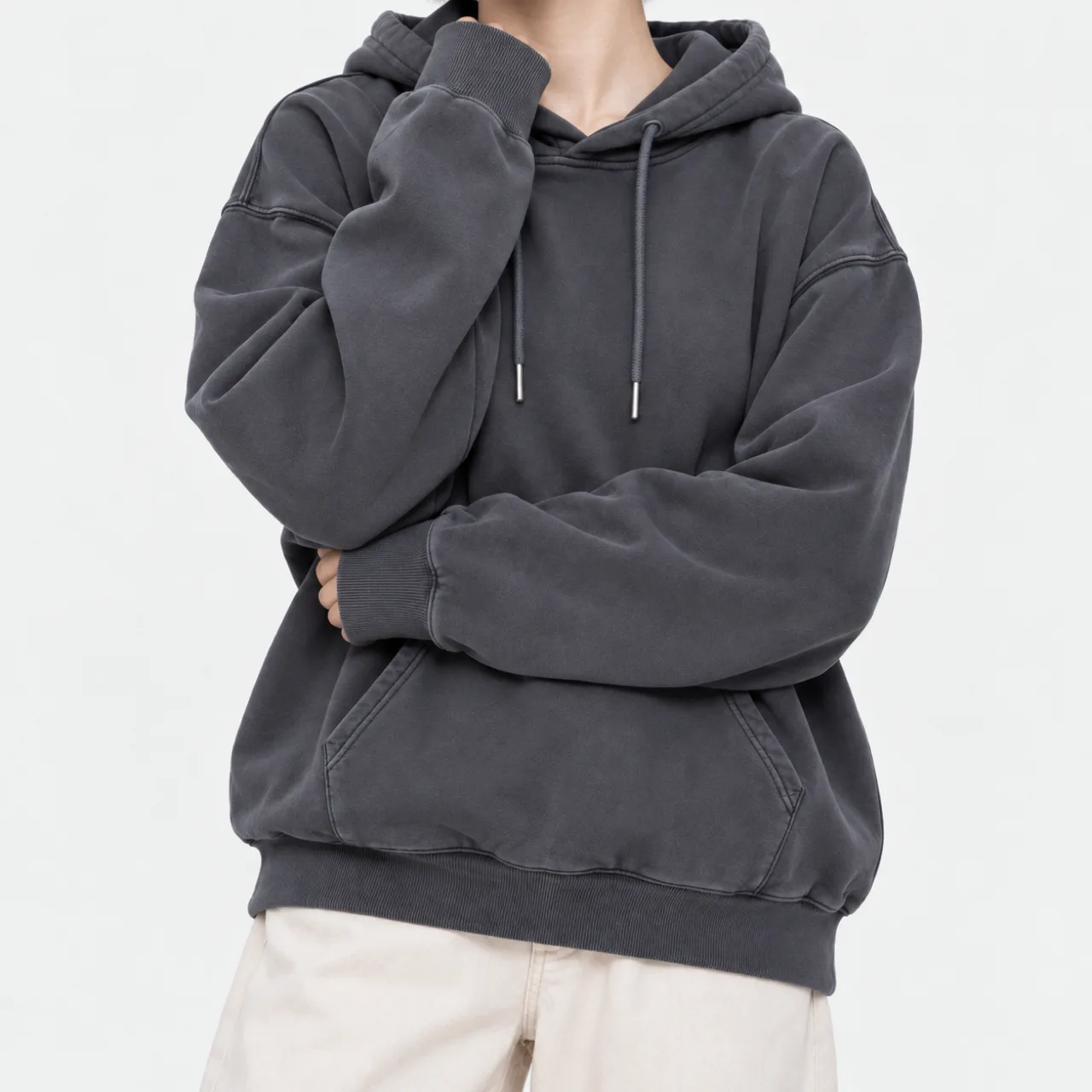 Front view of a model wearing a charcoal vintage pigment-washed hoodie