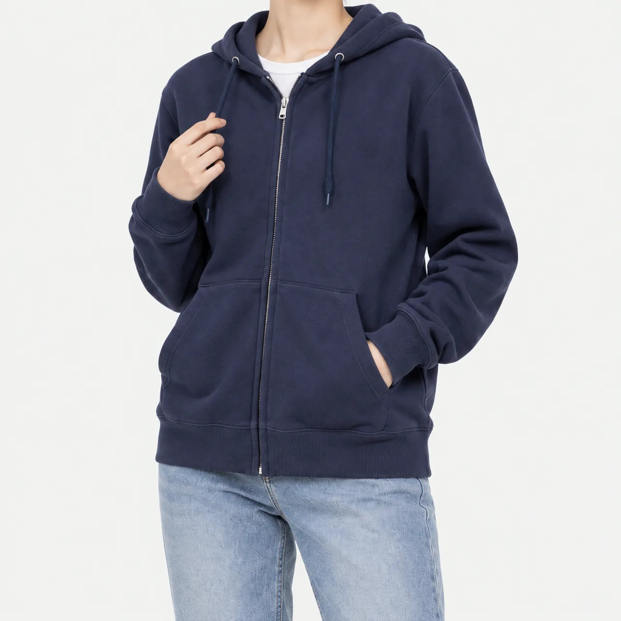 A model wearing a navy basic French terry zip-up hoodie with a hand in the pocket