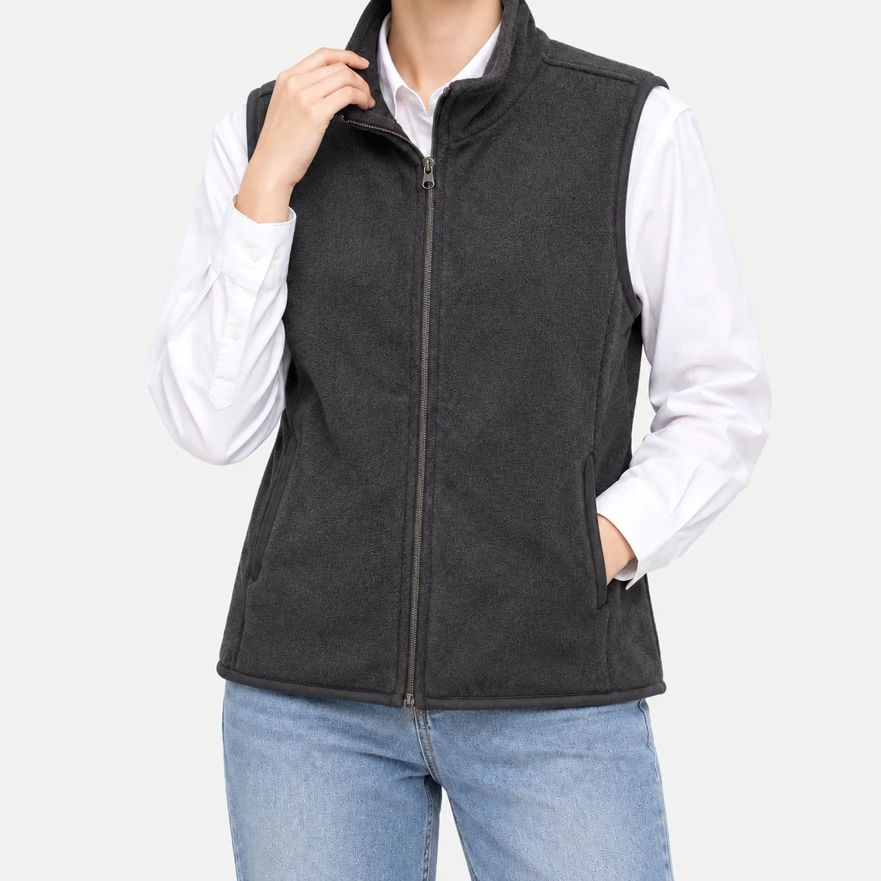 A model wearing a melange basic fleece vest with a hand in the pocket