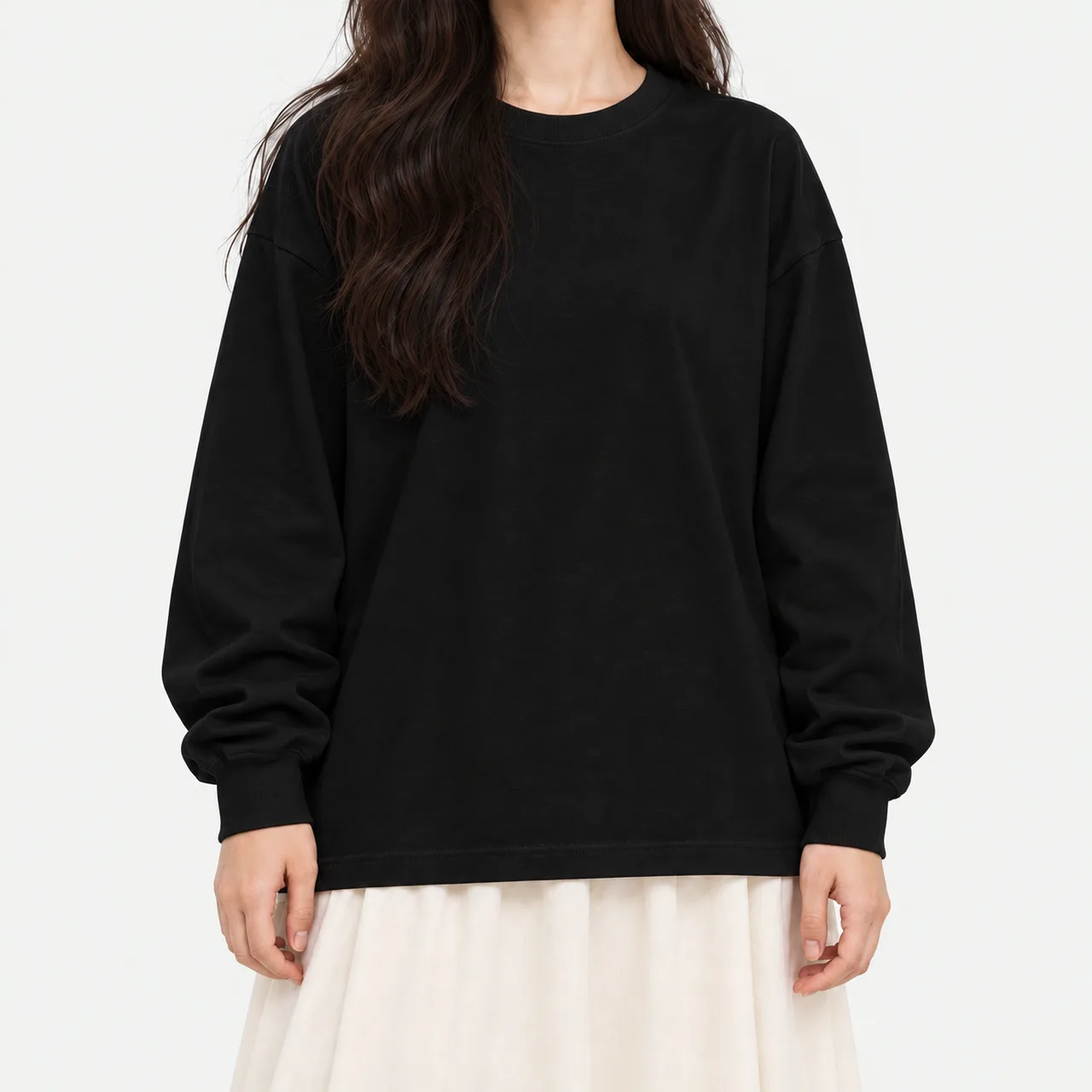 Front view of a model wearing a black oversized crewneck long sleeve T-shirt