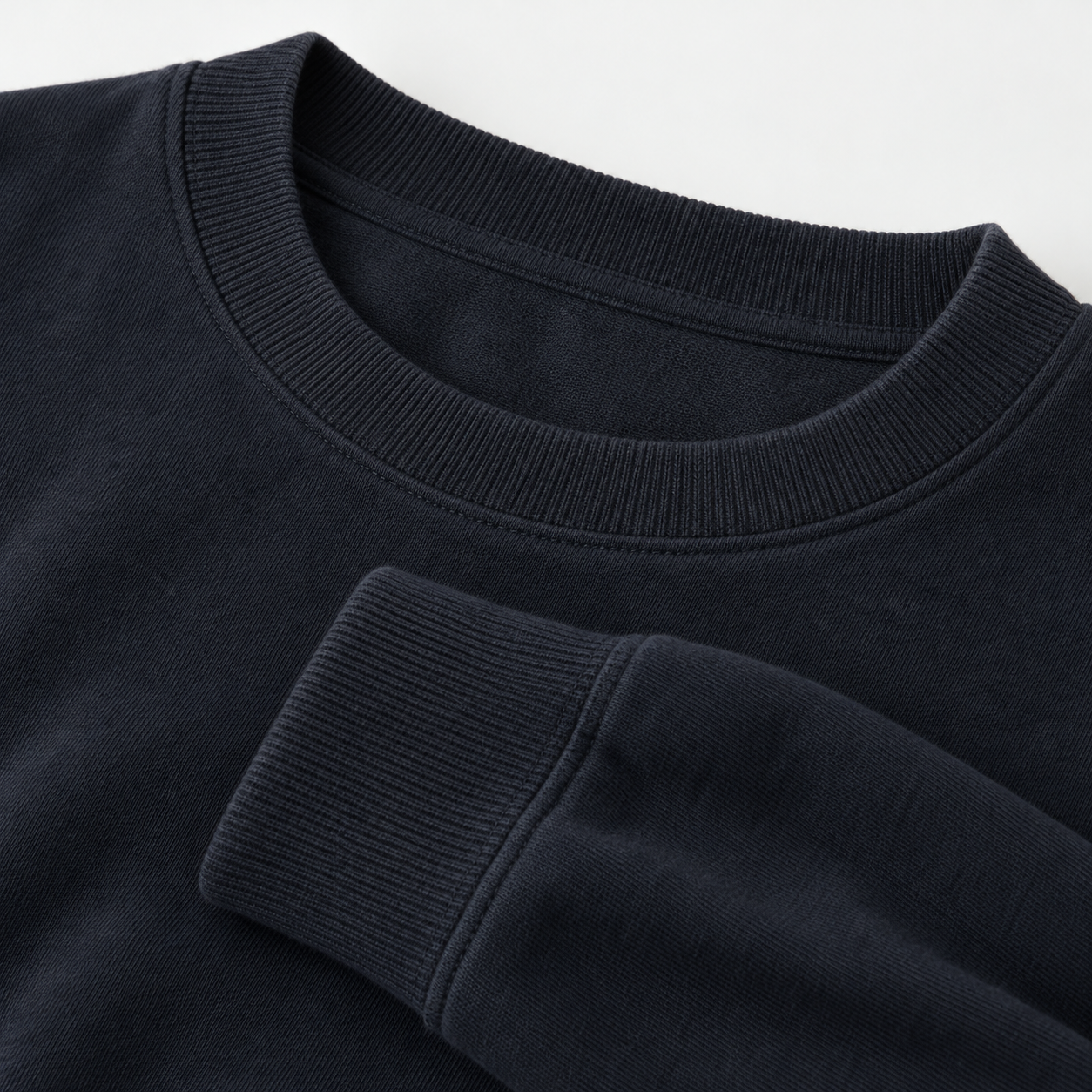 Close-up of the rib collar and rib cuff on a navy light sweatshirt
