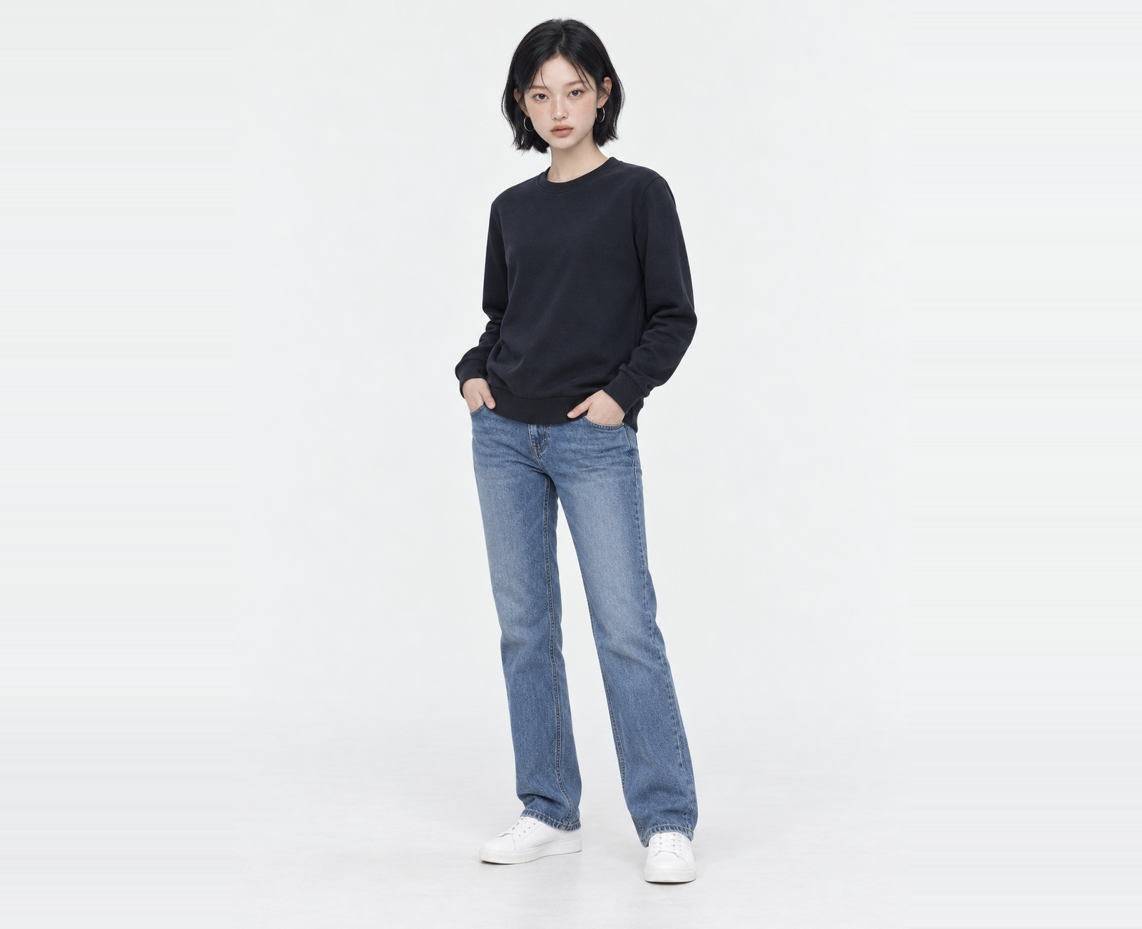 Full-length shot of a woman wearing a navy light sweatshirt in S, both hands in her pockets